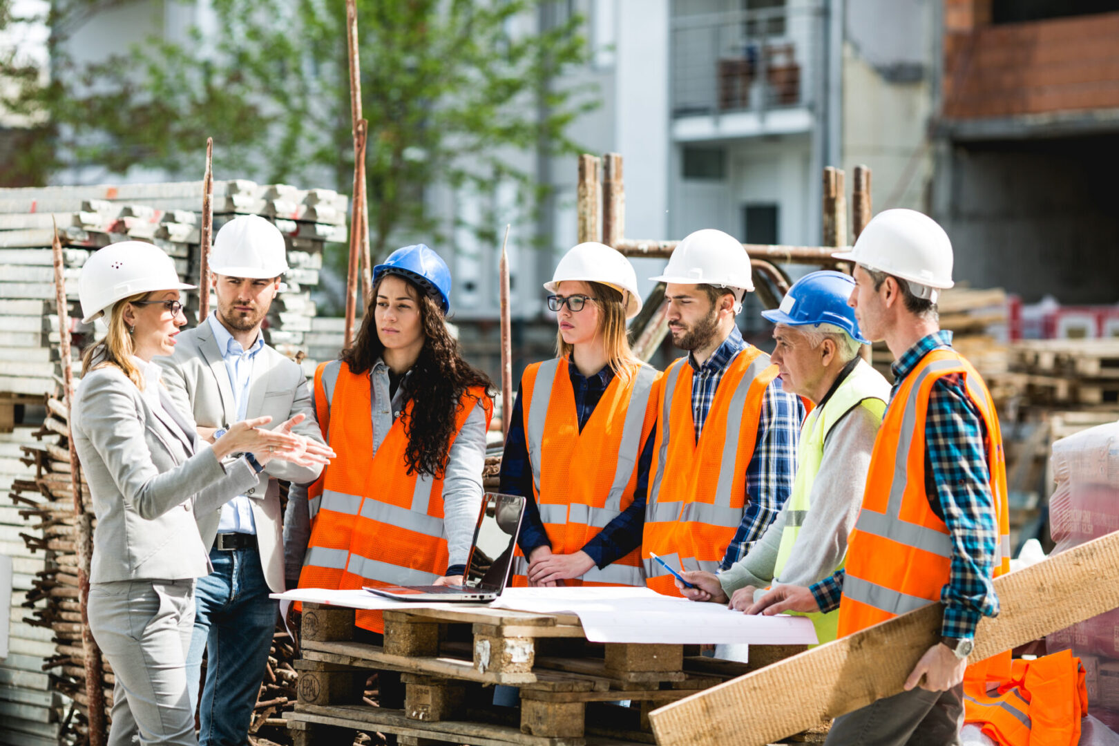 Construction workers talking on site